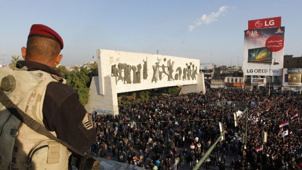 Iraqis, mostly supporters of prominent cleric Moqtada Sadr, take part in a mock funeral procession in Baghdad on February 14, 2017, to pay their respects to seven people killed last week during a protest for electoral reform. (AFP/Sabah Arar)
