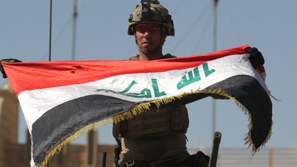 An Iraqi soldier celebrates victory over Daesh in Mosul last month (AFP)