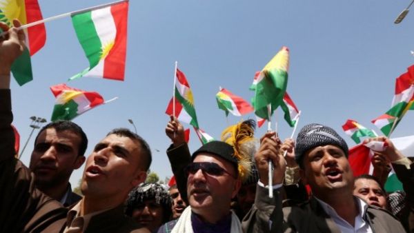 Iraqi Kurdish protesters wave flags of their autonomous Kurdistan region during a demonstration to claim for its independence. (AFP/Safin Hamed)
