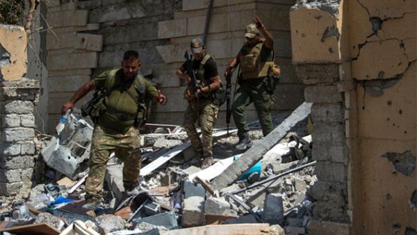 Iraq's elite Rapid Response Division patrol a medical complex in Al-Shifaa neighbourhood, on the west bank of Mosul, on July 1, 2017. (AFP/ Fadel Senna)