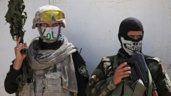 Shiite militiamen in Iraq have been accused of carrying out war crimes by Amnesty International (AFP)