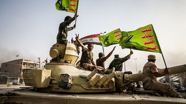 Militia fighters from the Popular Mobilization Forces celebrate a victory against Daesh, June 2016 (Wikimedia Commons)