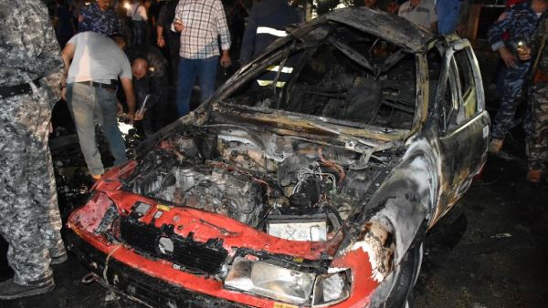 Iraqi security forces inspect the scene of a car bomb explosion that targeted a shop selling alcohol in the mainly Kurdish Iraqi city of Kirkuk on September 16, 2017. (Marwan Ibrahim/AFP)