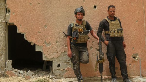 Iraqi counter-terrorism forces lean against a wall riddled with bullet holes in Fallujah. (AFP/Jean Marc Mojon) Iraqi counter-terrorism forces lean against a wall riddled with bullet holes in Fallujah. (AFP/Jean Marc Mojon)