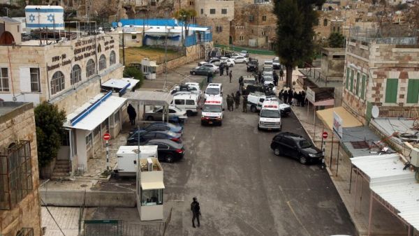 Police an ambulances respond to a shooting attack in January near the Ibrahimi Mosque. (AFP/Hazem Bader)