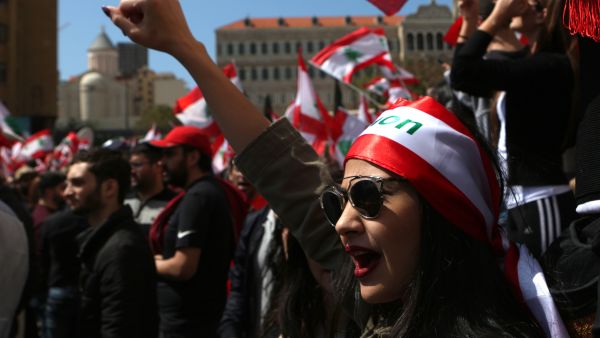 A Lebanese woman raises her fist as she shouts slogans during a protest in downtown Beirut on March 19, 2017, against the Lebanese Parliament's newly approved taxes. (AFP/Patrick Baz)