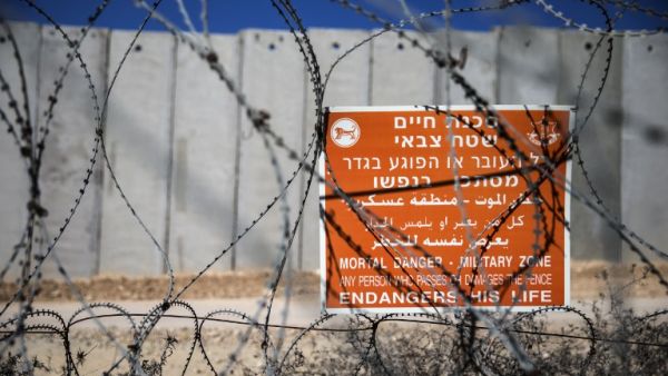 A general view shows a warning sign along Israel's controversial separation barrier between Israel and the West Bank near the south of Nablus on February 7, 2017. (AFP/Jack Guez)