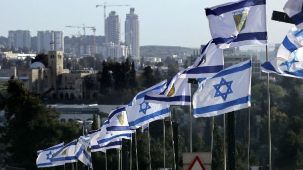 A picture taken on March 26, 2017 shows the flags of Israel and the municipality of Jerusalem flying outside the Jerusalem's Old City. (AFP/Thomas Coex)
