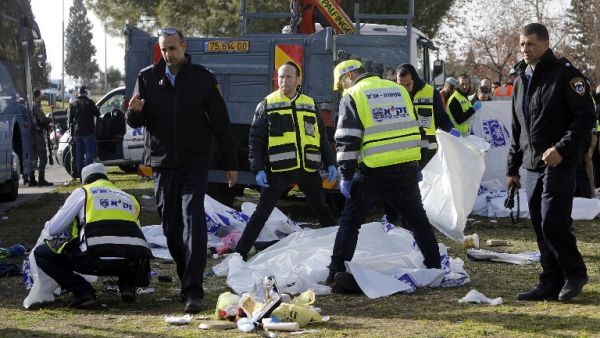 Israeli security forces and emergency personnel gather at the site of a vehicle-ramming attack in Jerusalem on January 8, 2017. (AFP/Menahem Kahana) Israeli security forces and emergency personnel gather at the site of a vehicle-ramming attack in Jerusalem on January 8, 2017. (AFP/Menahem Kahana)