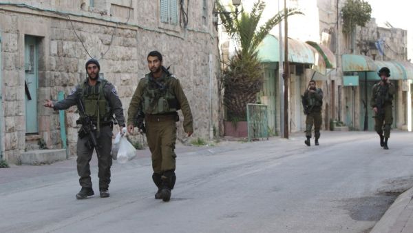 Israeli forces walk through the streets of Hebron, in the West Bank. (AFP/Hazem Bader)