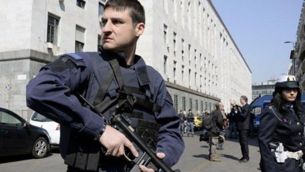 Police officers stand guard outside a court in Milan. (AFP/File) Police officers stand guard outside a court in Milan. (AFP/File)