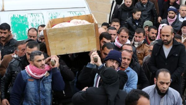 Jordanian mourners carry the coffin of Ibrahim Bashbsha, a day after he died in an attack, on December 19, 2016 during his funeral in Karak, around 70 miles south of the capital Amman. (AFP/Khalil Mazraawi)