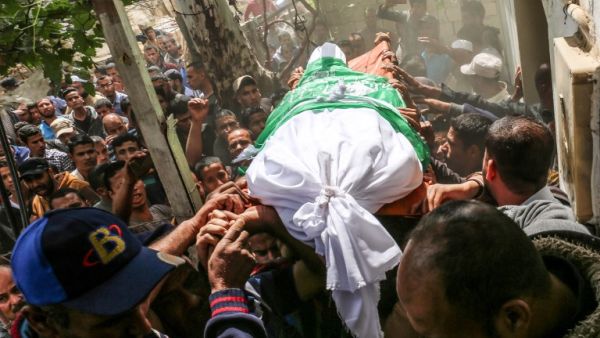 Mourners carry the body of 40-old Palestinian Jaber Abu Mustafa during his funeral/AFP