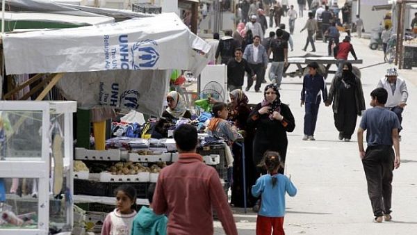 Syrian refugees walk past a makeshift market in Zaatari refugee camp in north Jordan. (AFP/Khalil Mazraawi)