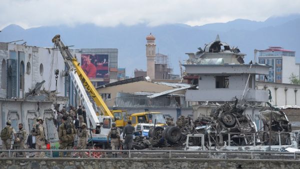 Afghan forces gather at the site of a car bomb in Kabul on April 19. (AFP/Shah Marai)