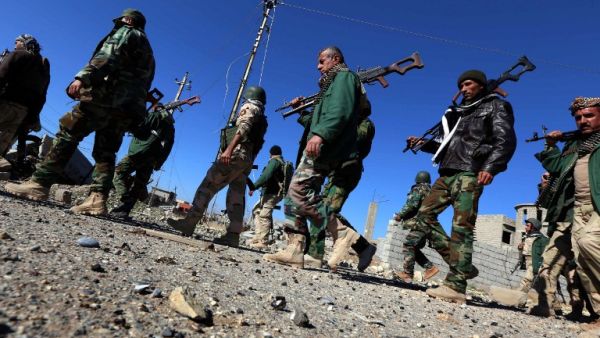 Kurdish and Yazidi fighters walk through Sinjar after reclaiming the town from Daesh. (AFP/Safin Hamed)