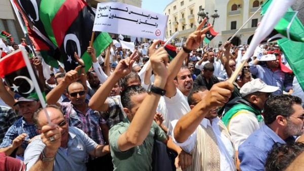 Protesters shout slogans waving national flags during a demonstration on Algeria Square to demand the removal of arms and the evacuation of unofficial armed groups on July 7, 2013 in the Libyan capital Tripoli.(MAHMUD TURKIA /AFP)
