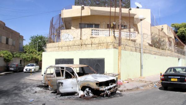 A picture taken on outside the Russian embassy in Tripoli shows a car that was destroyed during an attack. Russia has evacuated all embassy staff from Libya. (Image credit: AFP)