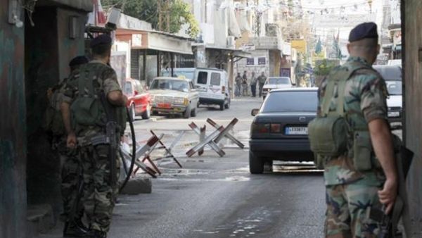 Members of Lebanese General Security observe passing cars at a checkpoint. (AFP/File)