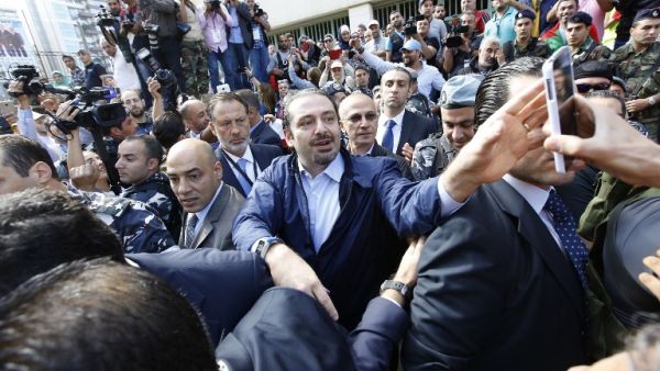 Former Lebanese Prime Minister Hariri takes a selfie with voters outside of a polling station. (AFP/Anwar Amro)