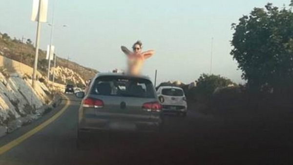 Police in Lebanon are looking for a woman who exposed her breasts from a car on a highway. (Daily Mail)