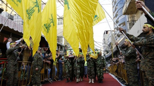 Members and supporters of Hezbollah carry the coffins of Hezbollah's commander Hatem Hamadeh (R) and militant Jalal al-Effeh (L), who were killed in combat alongside Syrian government forces in Syria, on October 18, 2016. (AFP/Anwar Amro)
