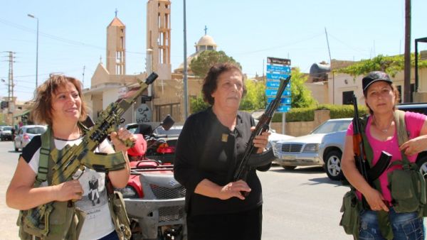 Lebanese Christian women hold weapons as residents of the Christian village of al-Qaa, near the Lebanon's border with war-ravaged Syria, secure the area on June 28, 2016 after two waves of suicide bombings struck the village killing and wounding several people. (AFP/Stringer)