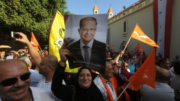 Supporters of Lebanon's Free Patriotic Movement celebrate the election of their leader MP Michel Aoun (portrait) in the town of Jdeideh north of Beirut on October 31, 2016. (AFP/Marwan Tahtah)