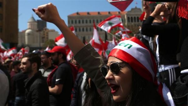 A Lebanese woman raises her fist as she shouts slogans during a protest in downtown Beirut. (AFP/ File Photo)