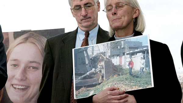 Craig and Cynthia Corrie speak about their daughter Rachel, shown on a poster, at a press conference on Capitol Hill/ AFP