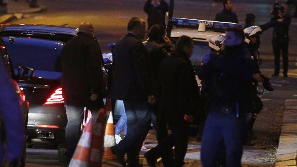 Lebanese Prime Minister Saad Hariri (C), surrounded by security personel, speaks on the phone as he arrives in Paris early November 18, 2017 (Geoffroy Van Der Hasselt/AFP)