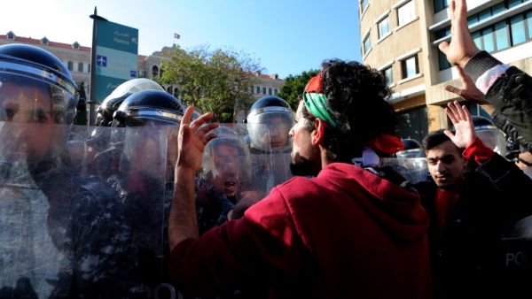 Lebanese demonstrators scuffle with riot police during a protest against the government's decision to raise taxes to cover a salary increase for teachers and other public servants, in downtown Beirut, on March 19, 2017. (AFP/Stringer)