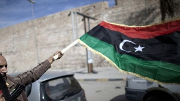A man waves a Libyan flag in Tripoli. (AFP/File)