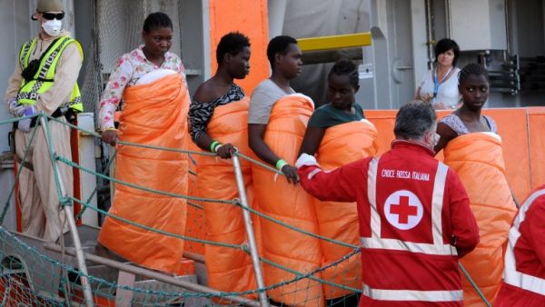Women disembark from the Siem Pilot on October 24, 2016 after rescue operations of migrants at see during the weekend. (AFP/Stringer)