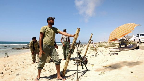 Members of the self-styled Libyan National Army, loyal to the country's east strongman Khalifa Haftar, fire mortar shells during clashes with militants in Benghazi's central Akhribish district on July 19, 2017 (AFP)