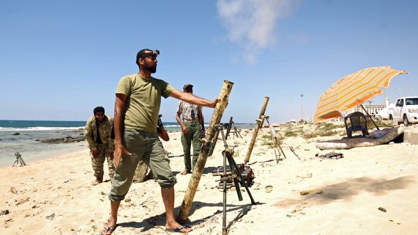 Members of the self-styled Libyan National Army, loyal to the country's east strongman Khalifa Haftar, fire mortar shells during clashes with militants in Benghazi. (AFP) 