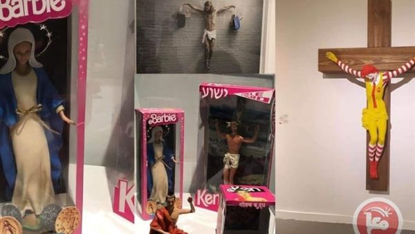 Sculptures depicting Jesus as “Ken” doll and Virgin Mary as “Barbie” doll and the Ronald McDonald on a cross being displayed in Haifa Museum and sparked controversy and anger. (Twitter)