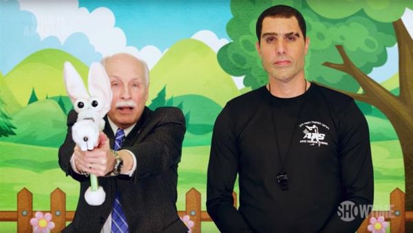Larry Pratt the lobbyist and executive director emeritus of Gun Owners of America with Sacha Baron Cohen in the  "Who Is America?" series. (Showtime)