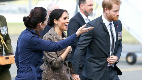 Britain’s Prince Harry and his wife Meghan with New Zealand’s Prime Minister Jacinda Ardern after arriving at the Wellington International Airport Military Terminal in Wellington. (Source: AFP)