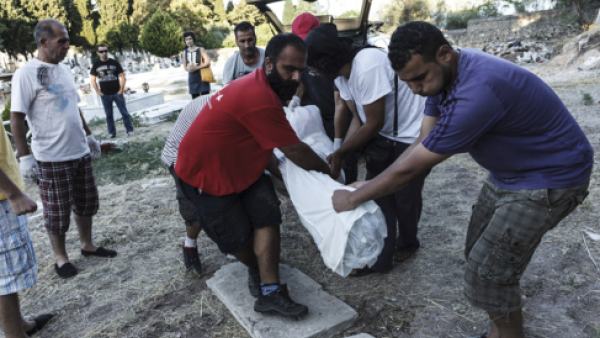 Men bury an unknown Syrian refugee on Lesbos. (AFP/Achilleas Zavallis)