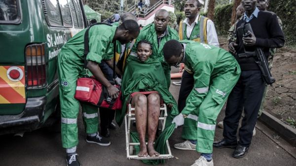 An injured woman is evacuated from the scene of an explosion at a hotel complex in Nairobi's Westlands suburb on January 15, 2019, in Kenya. (AFP)