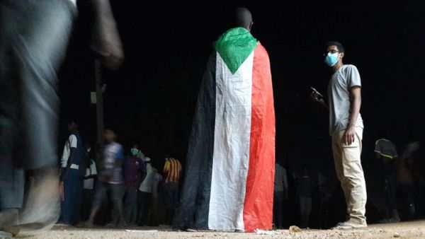 A Sudanese demonstrator wears a national flag during an anti-government protest in the Haj Yousef neighbourhood of the Bahari district in the capital Khartoum. (AFP/ File)