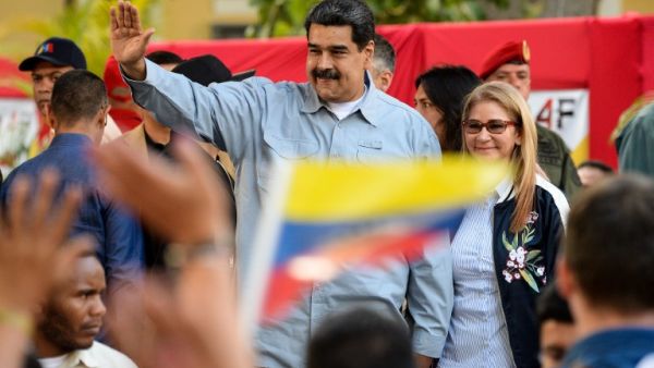 Venezuelan President Nicolas Maduro (L) delivers a speech next to his wife Cilia Flores, on the signature campaign he launched to put a halt to intervention threats against his government. (AFP)