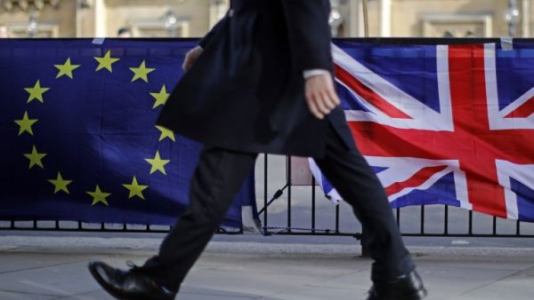 A man walks past the flags of Anti-Brexit protesters outside the Houses of Parliament in London on February 12, 2019. (AFP/ File)