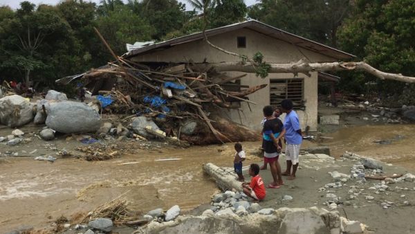 Tree trunks and debris washed away by flash floods are seen lodged in a damaged house in Sentani near the provincial capital of Jayapura, Indonesia. (AFP)