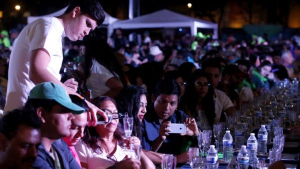 A man serves tequila as 1,486 people gather to hold a tequila tasting at the Plaza Liberacion in Guadalajara, Jalisco, Mexico, on March 24, 2019. (AFP/ File)