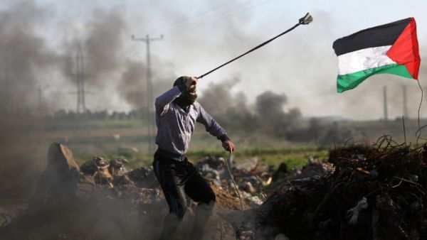Palestinian protesters hurls a rock at Israeli security forces during clashes near the Shejaiya area of Gaza City . (AFP/ File)