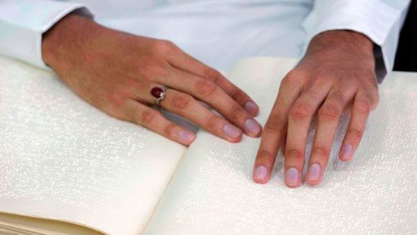 A blind Saudi reads in braille a copy of the Quran, Islam's holy book, inside a mosque on the first day of the holy fasting month of Ramadan. (AFP)