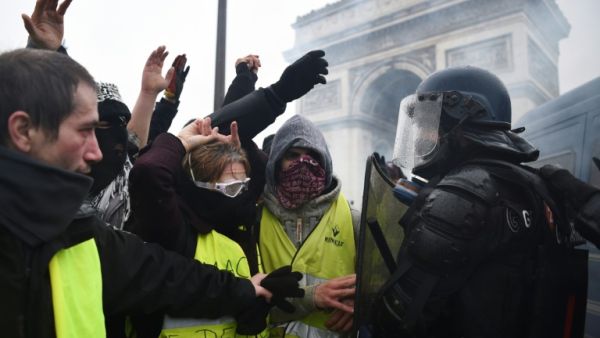 Riot police face demonstrators during a "Yellow vest" protest in Paris on December 1. (AFP/FILE)