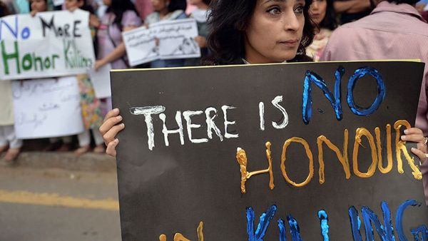 Human rights activists at a protest in Islamabad with sign reads " there is no honor in killing'. (AFP/File)